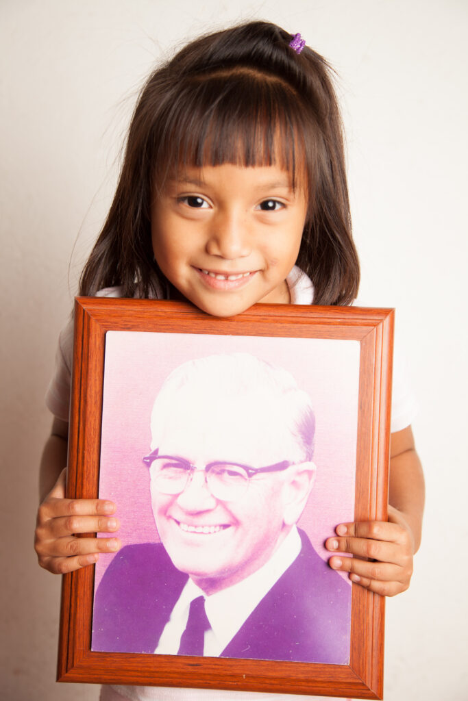 little girl shows a picture of Father wasson 